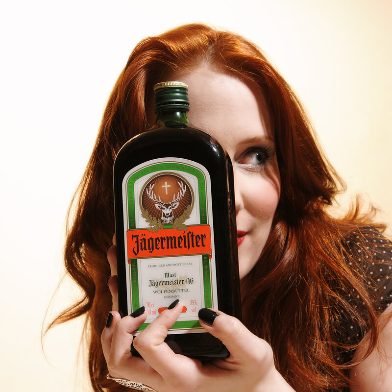 woman holding jagermeister bottle