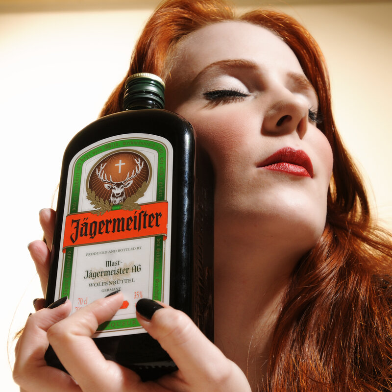 Woman holding Jagermeister bottle