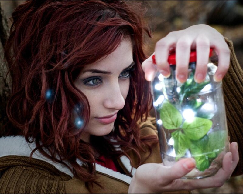 woman holding jar with lights