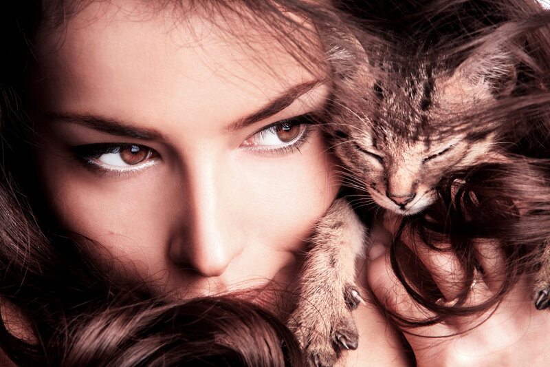Woman Holding Kitten — Brown