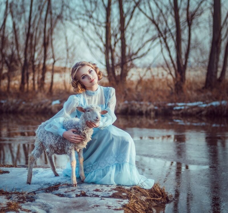 Woman Holding Lamb — Blue, Serene, Winter