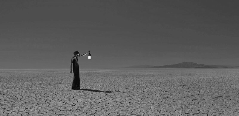 Woman Holding Lantern — Black, Desolate