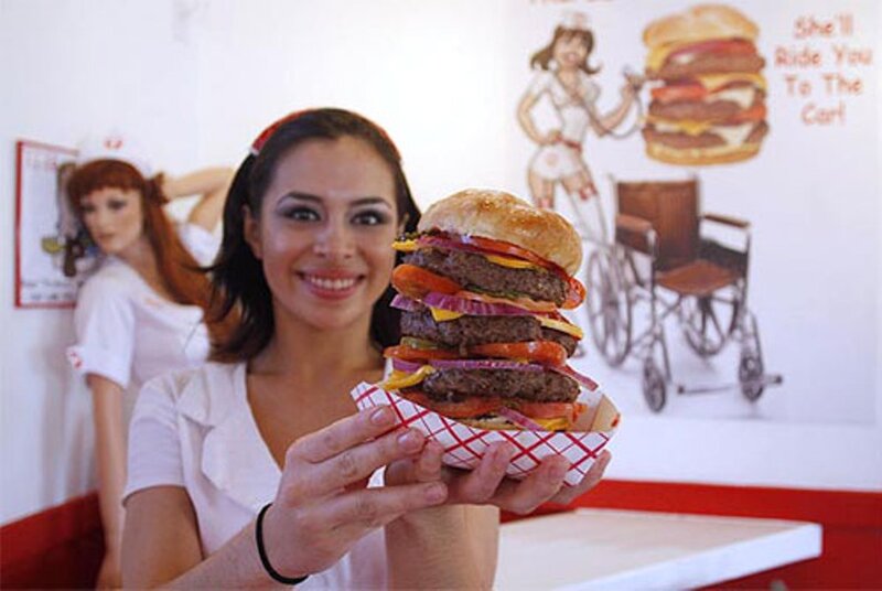 Woman Holding Large Burger