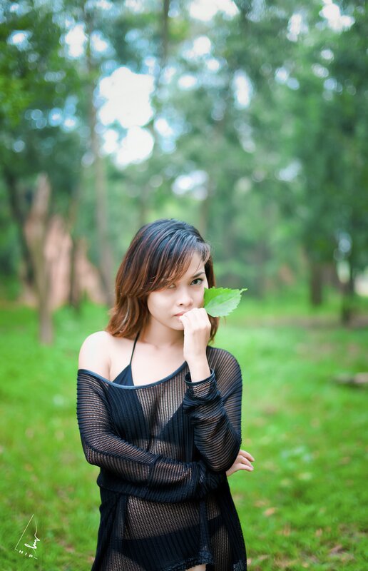 Woman Holding Leaf — Green, Serene, Afternoon