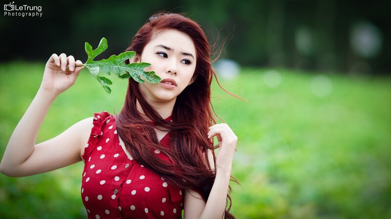 Woman Holding Leaf — Red, Serene