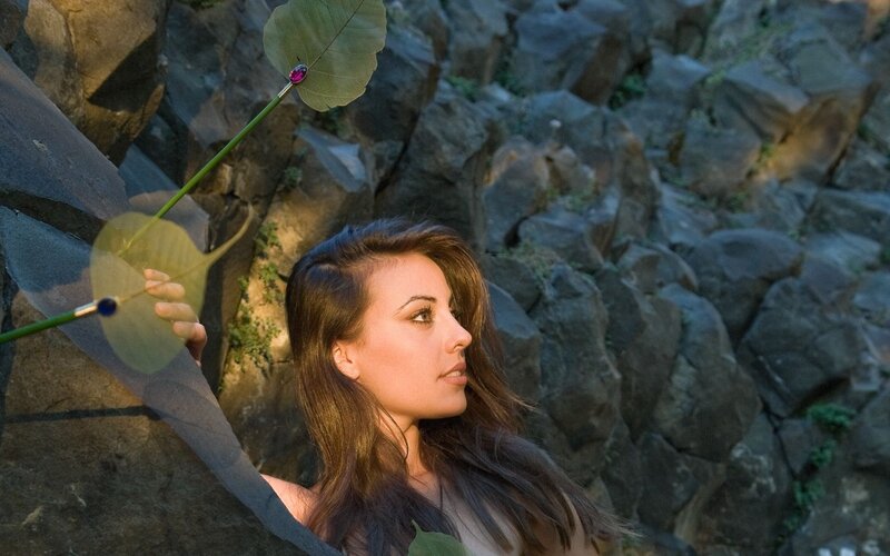 woman holding leafy staff