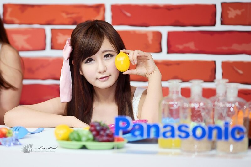 woman holding lemon at table