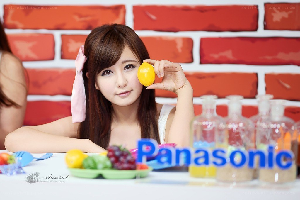 woman holding lemon at table