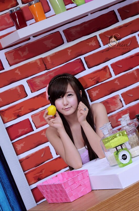 woman holding lemon in kitchen