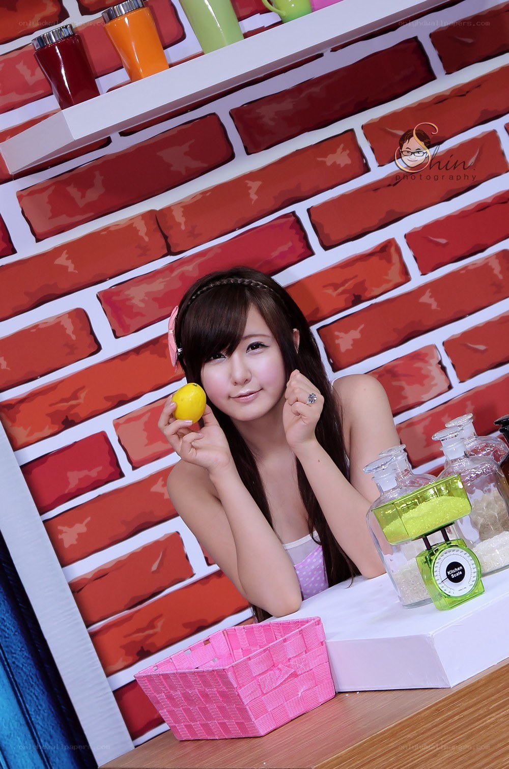 woman holding lemon in kitchen