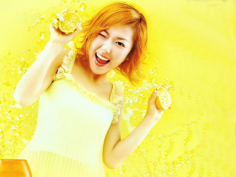 Woman Holding Lemons — Yellow