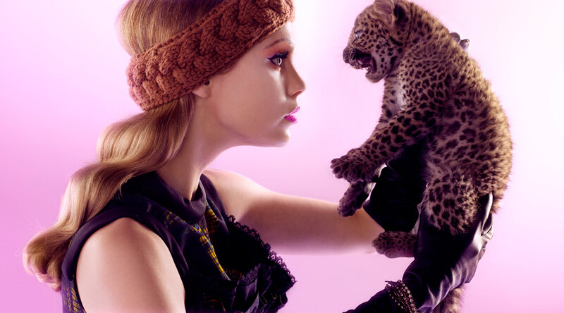 Woman Holding Leopard Cub