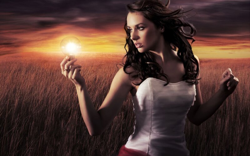 Woman Holding Light Bulb — Orange