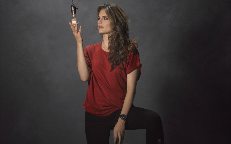 woman holding light bulb