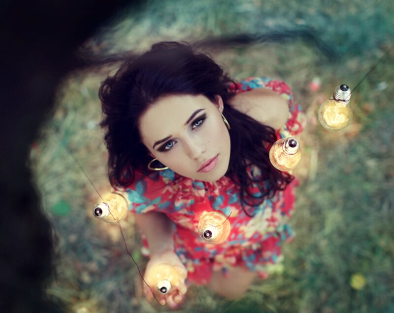 Woman Holding Light Bulbs — Red