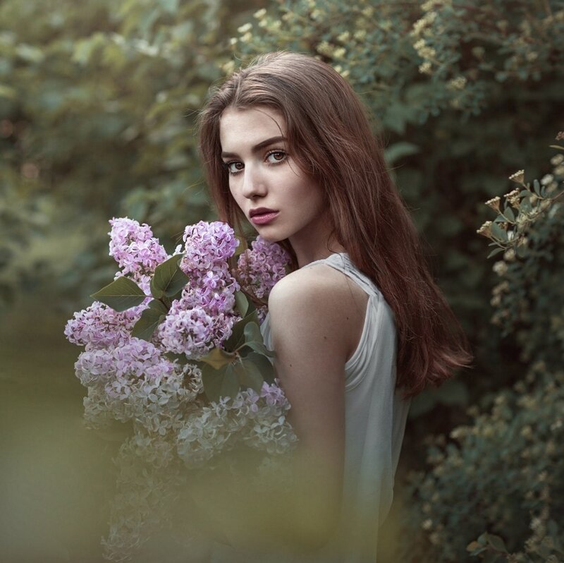 Woman Holding Lilac Flowers