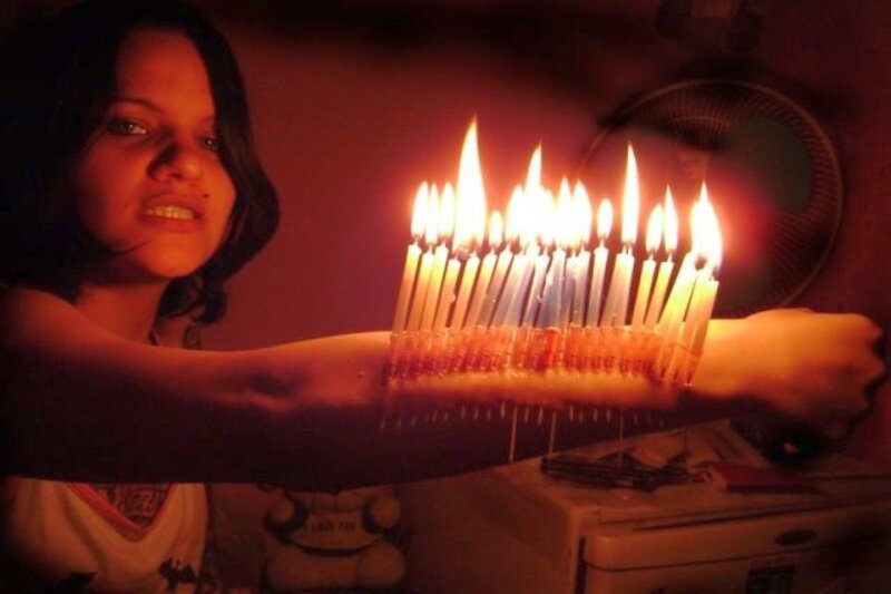 woman holding lit candles
