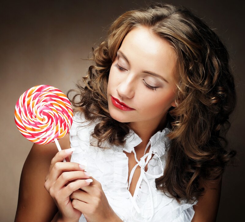 Woman Holding Lollipop — Brown