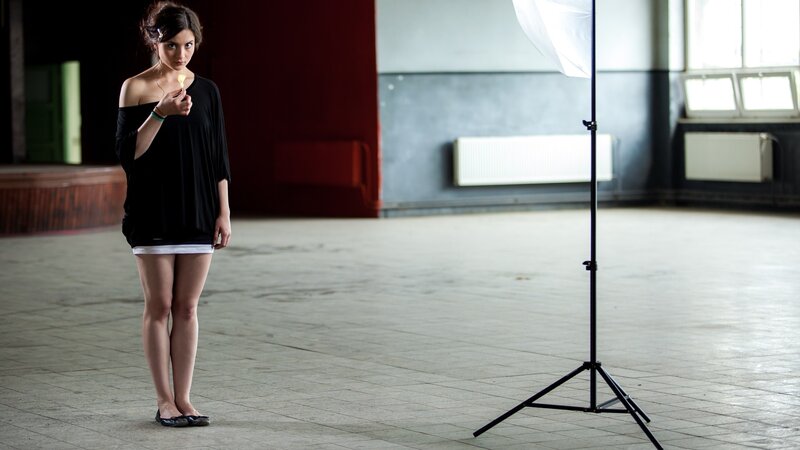 Woman holding lollipop in studio