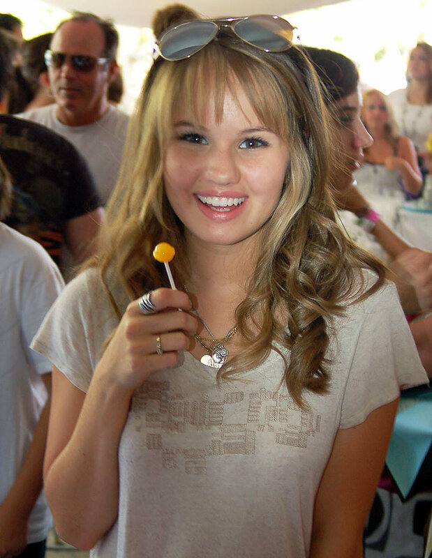woman holding lollipop smiling