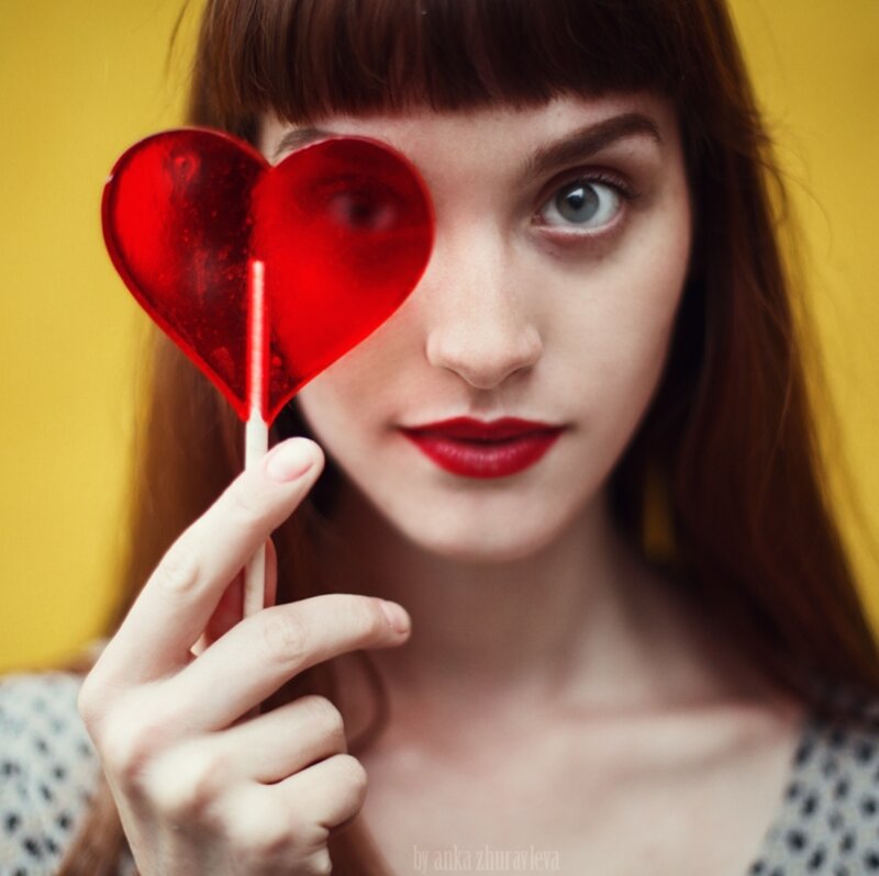 Woman Holding Lollipop — Yellow, Playful, Photograph