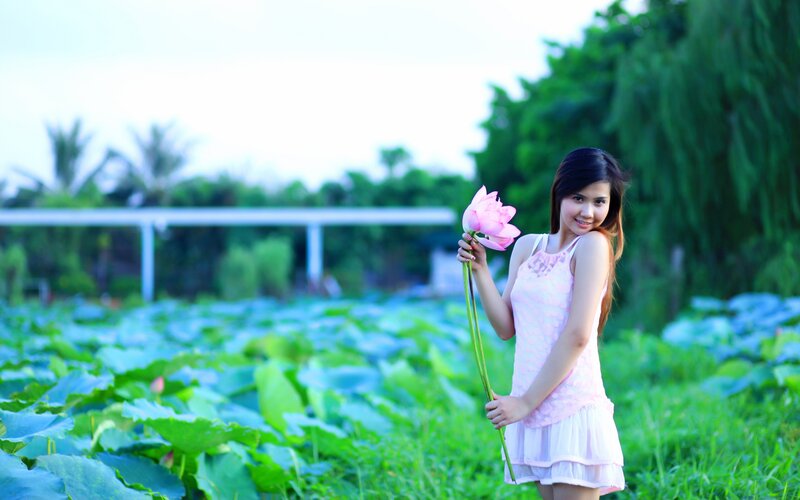 Woman holding lotus flower