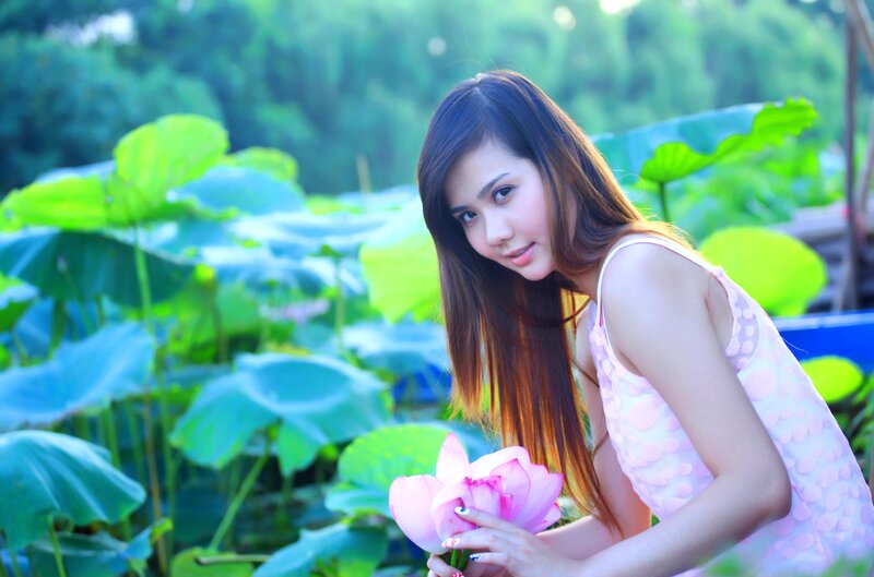 woman holding lotus flower