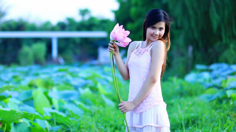Woman holding lotus flower