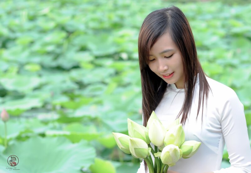 Woman holding lotus flowers