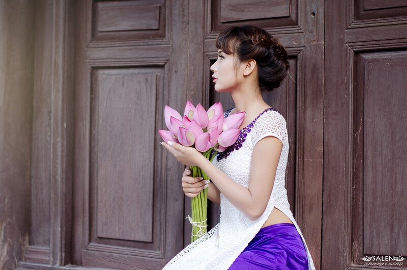 woman holding lotus flowers