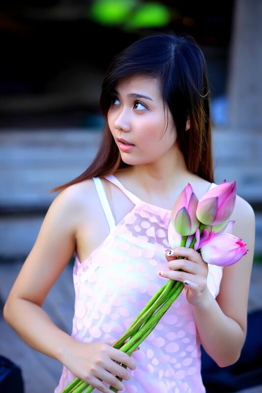 woman holding lotus flowers