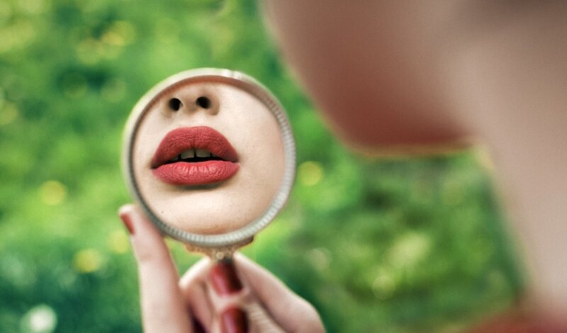 woman holding magnifying glass