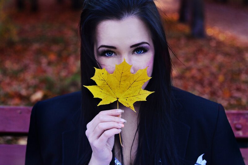 Woman Holding Maple Leaf — Yellow