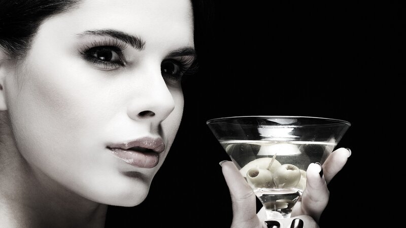 woman holding martini glass