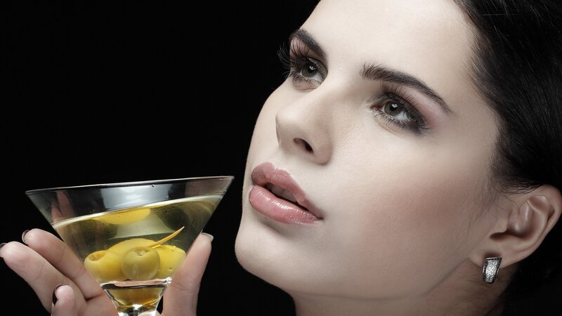 woman holding martini glass