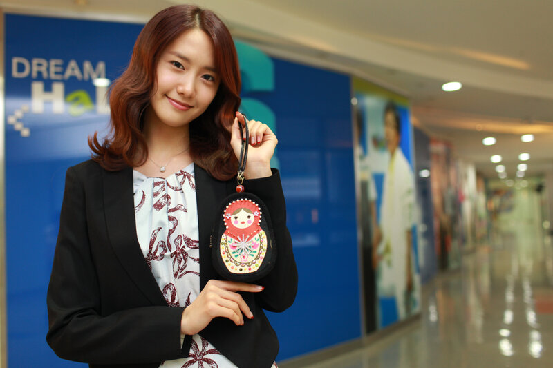 woman holding matryoshka purse