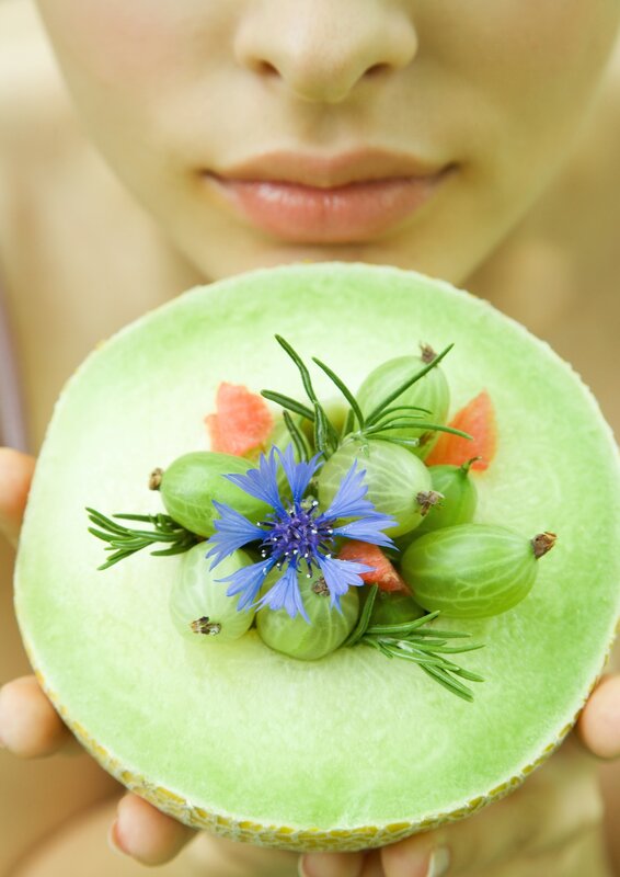 woman holding melon with garnish