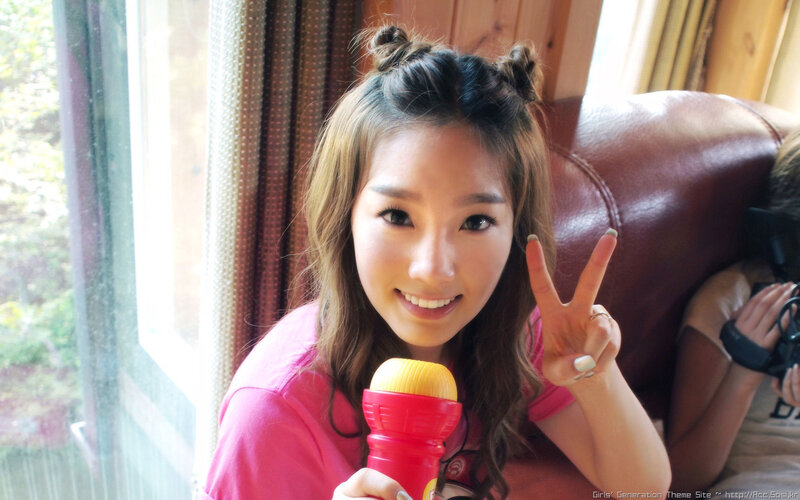 woman holding microphone and making peace sign