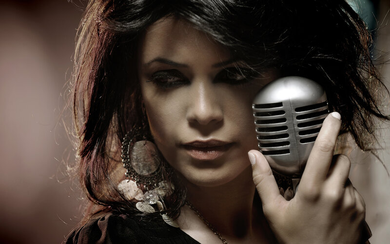 Woman Holding Microphone — Black, Dramatic, Photograph, Earring