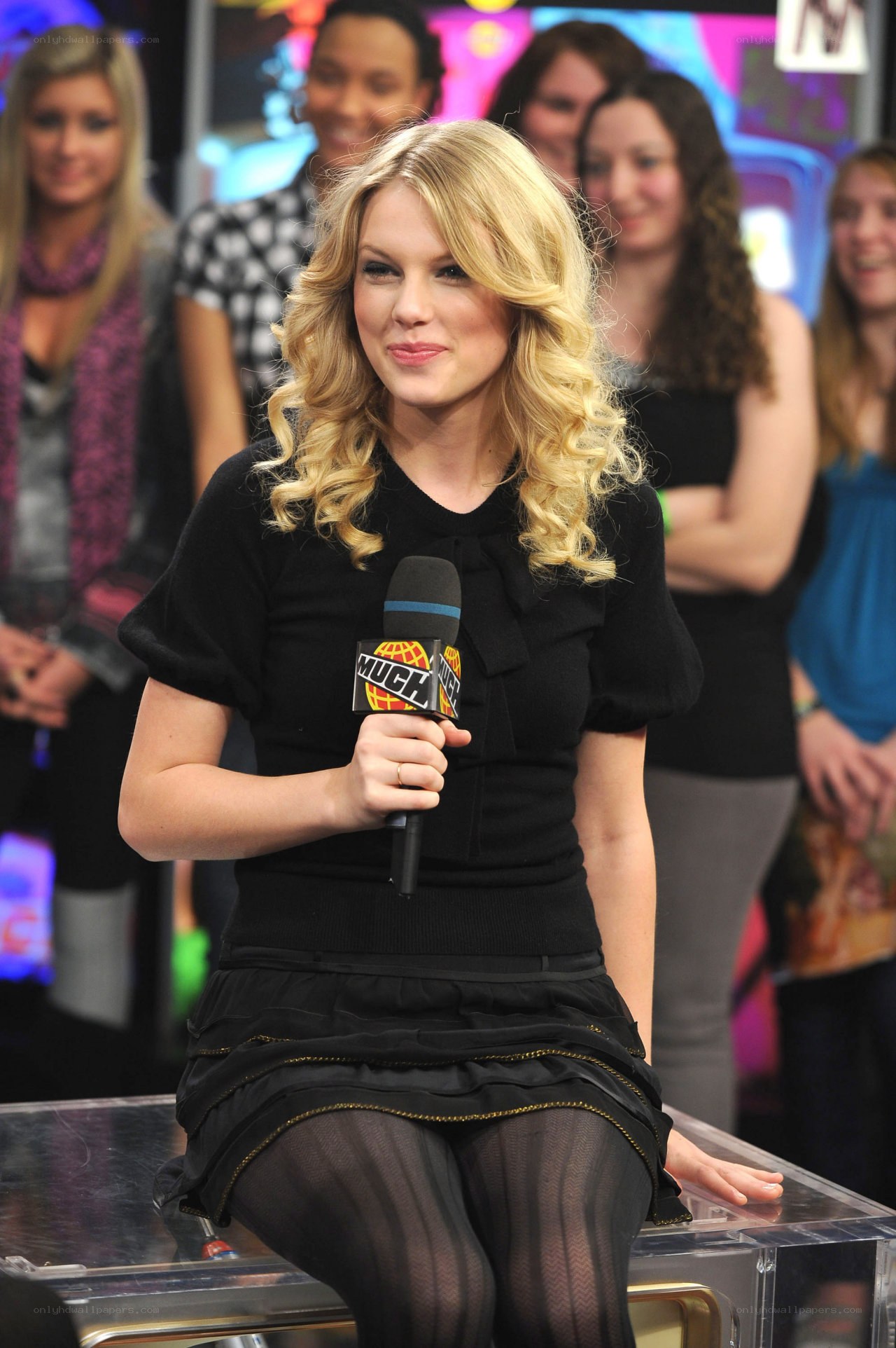 woman holding microphone on set