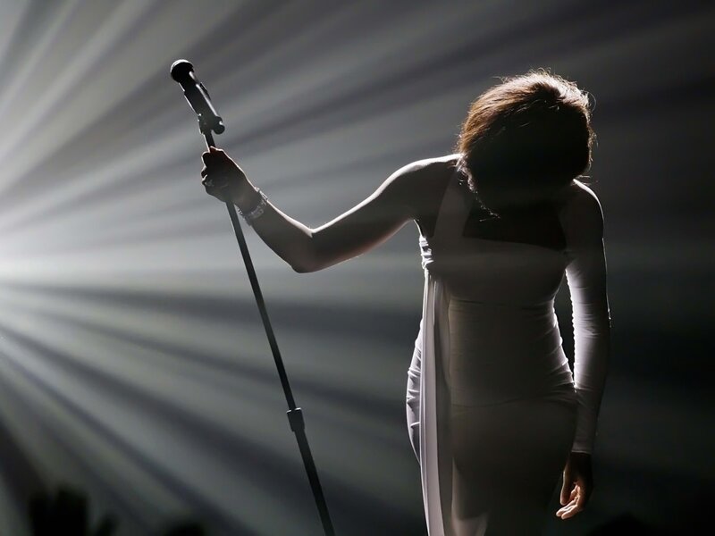 Woman Holding Microphone — White, Dramatic, Photograph