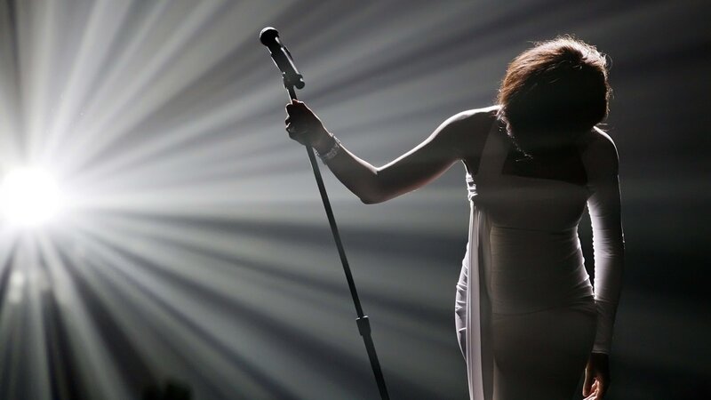 Woman Holding Microphone — White, Dramatic