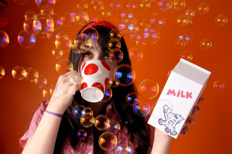 Woman Holding Milk Carton — Orange