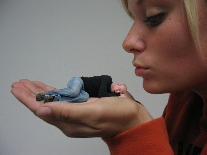 Woman holding miniature man