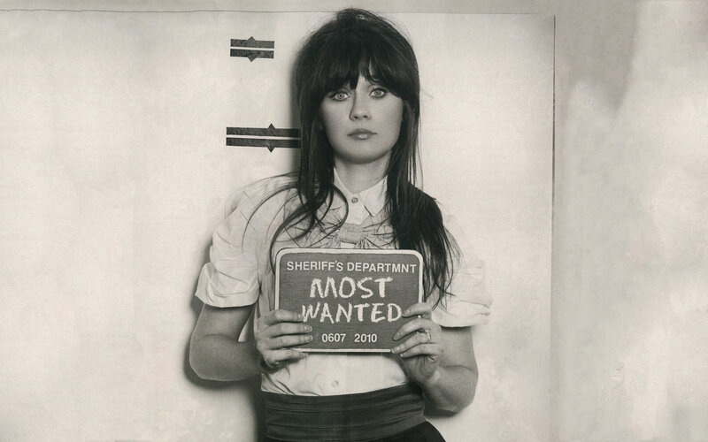 woman holding most wanted sign