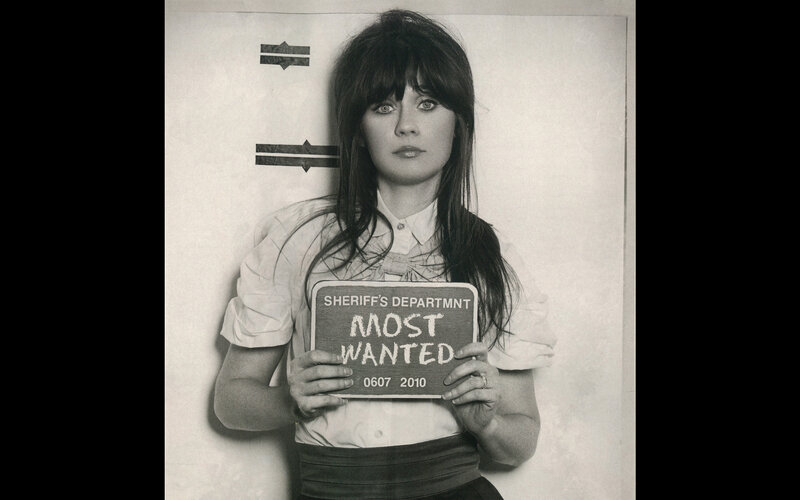 woman holding most wanted sign