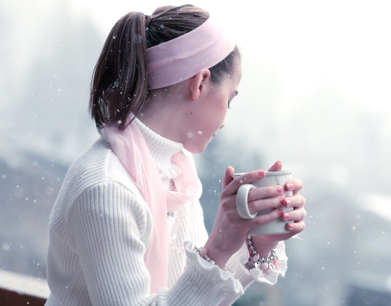 woman holding mug in snow