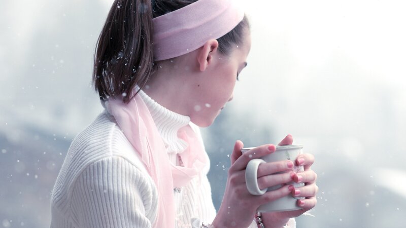 woman holding mug in snow