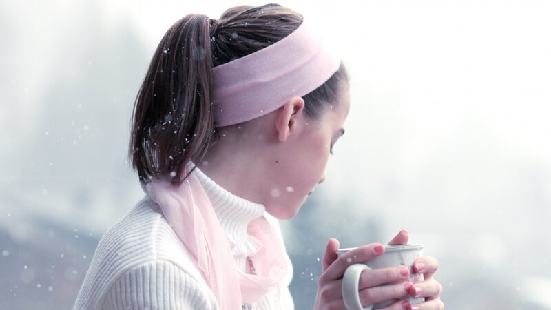 woman holding mug in snow