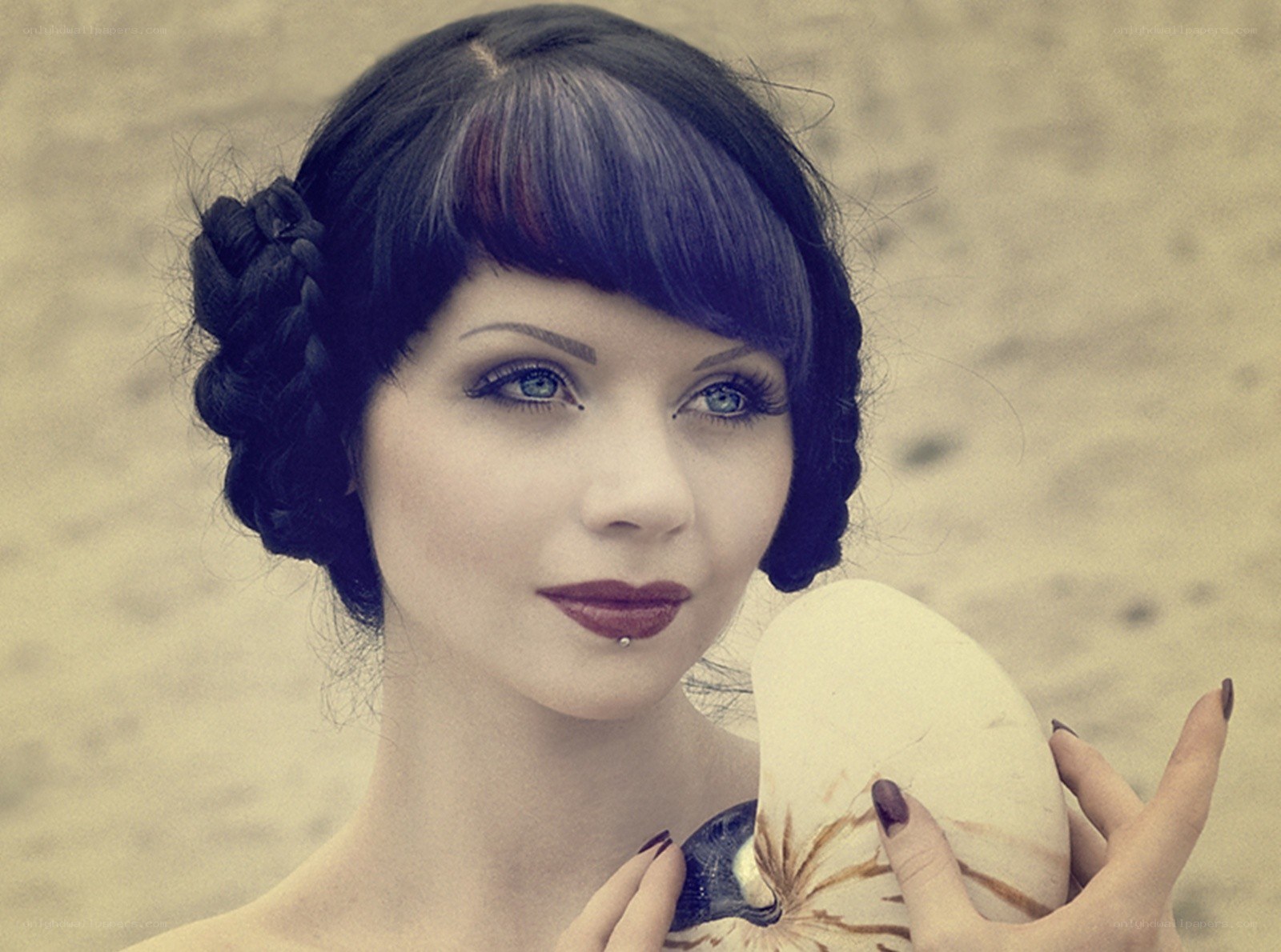woman holding nautilus shell